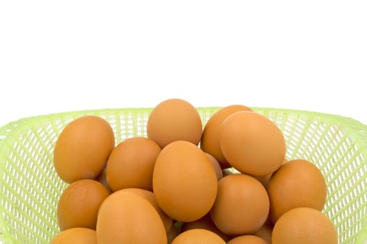 Eggs in basket isolated on white background