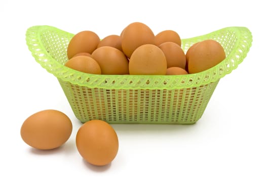 Eggs in basket isolated on white background