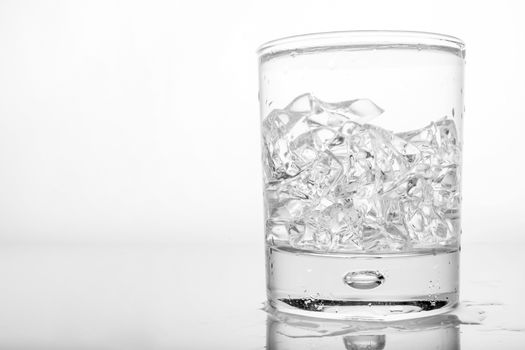 Glass of pure water with ice cubes.