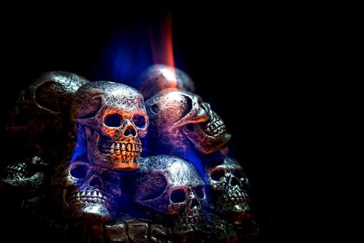 Burning skulls on black background