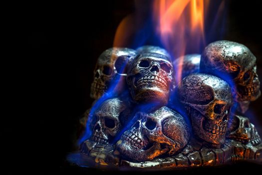 Burning skulls on black background