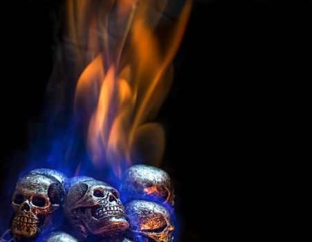 Burning skulls on black background