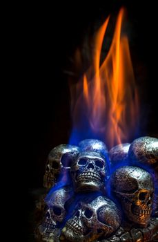 Burning skulls on black background