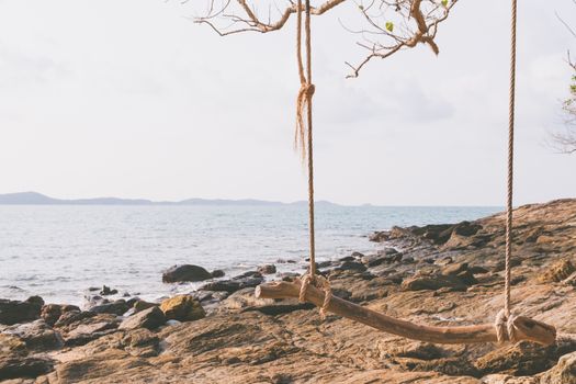 wood swing on the  beach. vintage filter effect