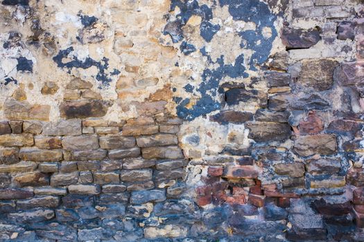 Detail shot of an old brick wall and crumbling cement UK