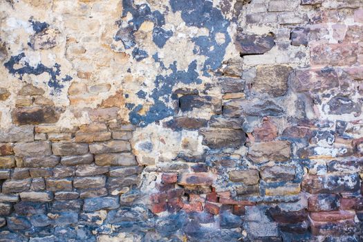 Detail shot of an old brick wall and crumbling cement UK