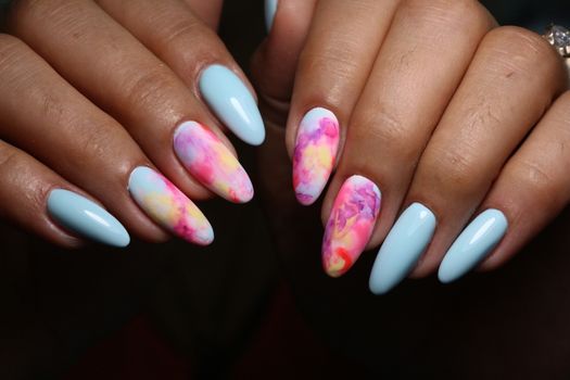 Multi-colored pastel manicure combined tone on tone with a striped background.