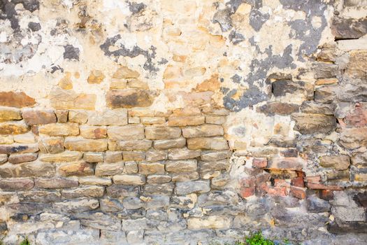 Detail shot of an old brick wall and crumbling cement UK