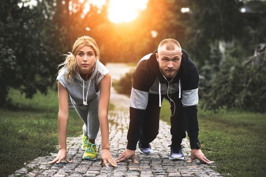 Urban sports - couple jogging for fitness in the city with beautiful nature.