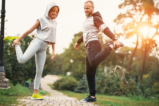 Urban sports - couple jogging for fitness in the city with beautiful nature.
