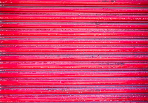 red roller shutter on the door of closed retail premises