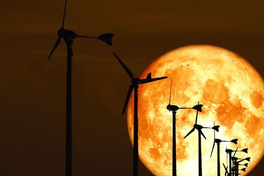 blood moon back Wind turbines produce wind energy which is a clean energy, Elements of this image furnished by NASA