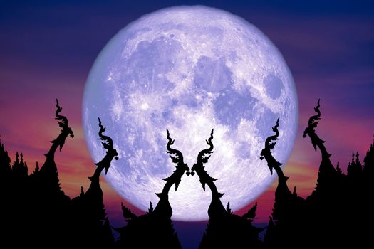 super blue moon back over silhouette art on roof of Buddhist temple and sunset sky, Elements of this image furnished by NASA