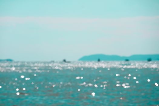 Blur reflection of sunlight on blue sea water surface island background
