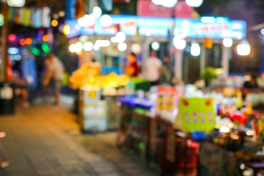 blurred colorful light street food of china town at local market in pattya city