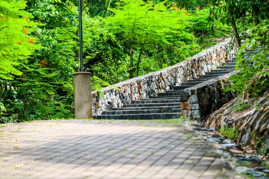 Granite stairs and stone walls in the garden and green trees