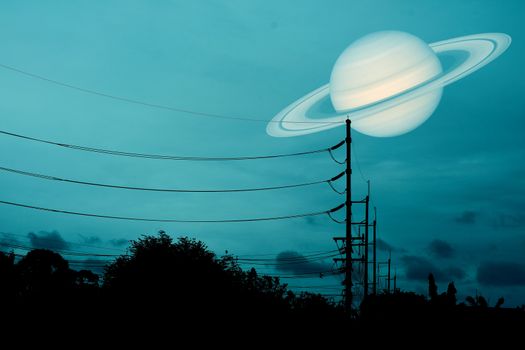 Saturn floats in the sky above the shadow of an electric pole, Elements of this image furnished by NASA