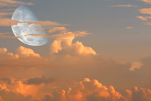 half moon back on silhouette heap cloud on sunset sky, Elements of this image furnished by NASA
