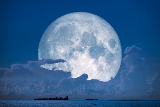 super snow moon back on night sky silhouette cloudon sea, Elements of this image furnished by NASA