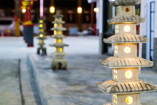 The five-story pagoda statue is decorated with decorative lanterns in the garden in china town