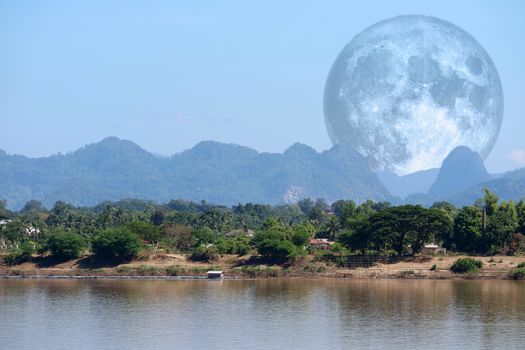 full milk moon back on silhouette mountain and river, Elements of this image furnished by NASA