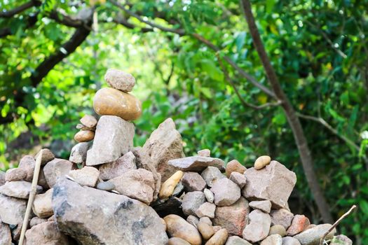 rock is arranged as a pagoda for worship of lord buddha and forest nature background