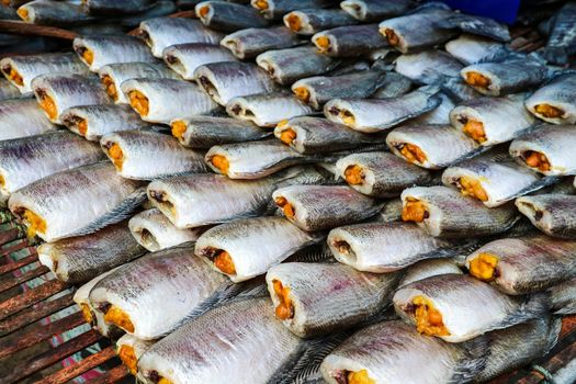 pattern of dried salted damselfish on threshing bamboo basket, its favorite food of thailand