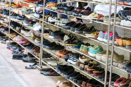 Shoes are organized in an orderly manner on the shelves inside a temple