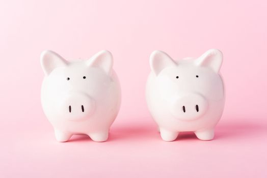 International Friendship Day, Front two small white fat piggy bank, studio shot isolated on pink background and copy space for use, Finance, deposit saving money concept