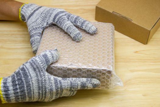 hand of man hold bubble wrap, for protection parcel product cracked or insurance During transit  