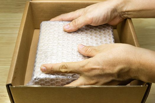 hand of man hold bubble wrap, for protection parcel product cracked or insurance During transit  