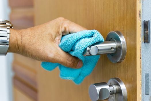 Prevention cleaning Door handles by Disinfectant solution for killing corona virus on touching surfaces, concept coronavirus COVID19
