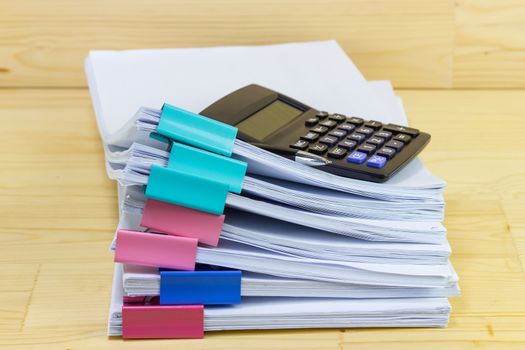 pile of papers with Calculator at work office for business on the table, concept document in work office
