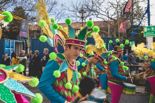 Loule, Portugal - February 25, 2020: percussionists parading in the street accompanying dancers in the parade of the traditional carnival of Loule city on a February day