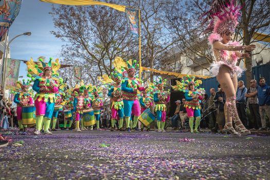 Loule, Portugal - February 25, 2020: percussionists parading in the street accompanying dancers in the parade of the traditional carnival of Loule city on a February day