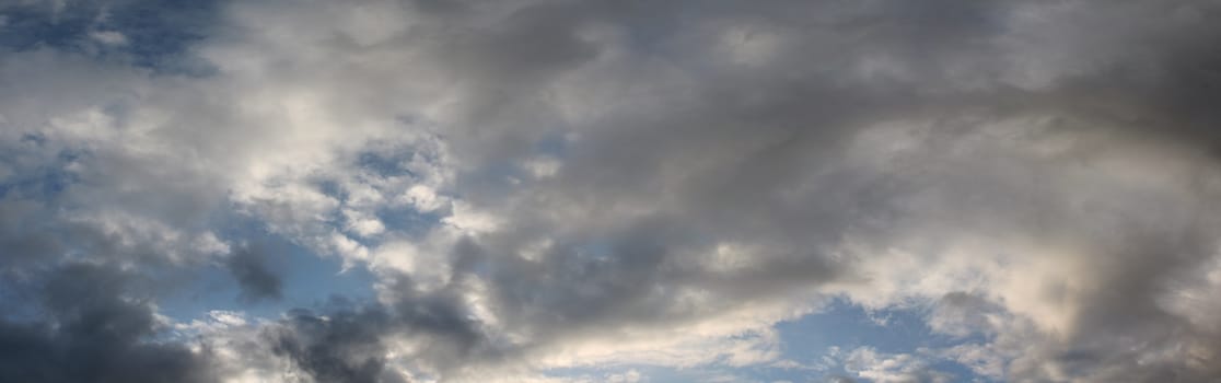 Stunning mixed cloud formation panorama in a deep blue summer sky.