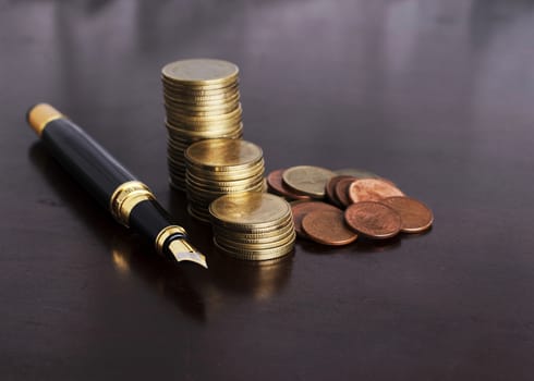 Money coins stack and Fountain Pen for Finance Concept