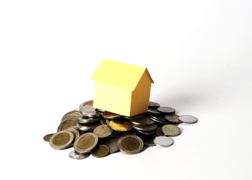 Yellow House and Coins stack on white background