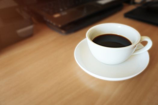 A cup of hot coffee on office table