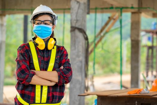 Construction worker wearing protective mask to Protect Against Covid-19 in construction site,Safety control from epidemics in construction site concept.