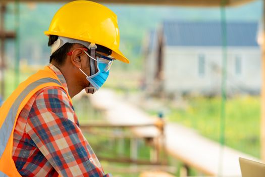 Construction worker wearing protective mask to Protect Against Covid-19 in construction site,Safety control from epidemics in construction site concept.