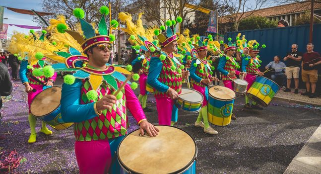 Loule, Portugal - February 25, 2020: percussionists parading in the street accompanying dancers in the parade of the traditional carnival of Loule city on a February day