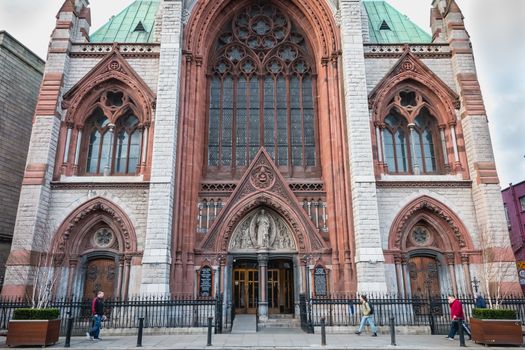 Dublin, Ireland - February 13, 2019: Street atmosphere and architecture of St. Augustine and St. John The Baptist Catholic Church that people visit on a winter day