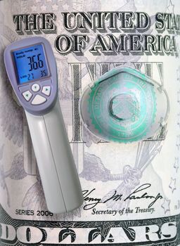 Thermometer Gun Infrared body Temperature Measurement. Medical mask protection banknote dollar bill US quarantine coronavirus financial crisis stock background health care