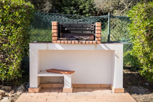 Charcoal barbecue in red brick in a garden in Portugal