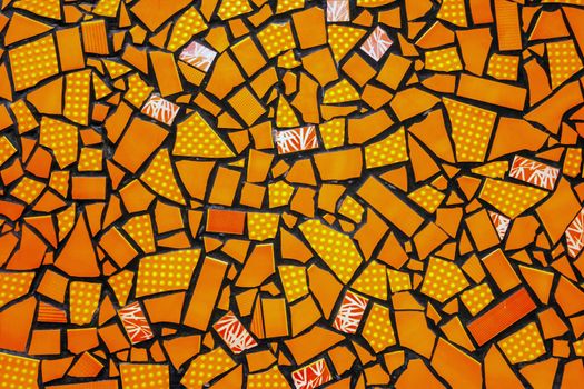 Broken ceramic tiles mosaic seamless tile-shard pattern background yellow orange colors