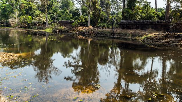 Ancient temple old ruin stone wall of Angkor wat Lost Khmer city in the jungle Siem Reap UNESCO World Heritage Site Cambodia.