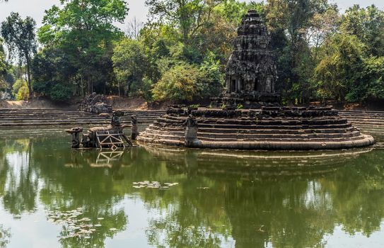 Pond Neak Pean artificial island to the Angkor temple complex Lost ancient Khmer Empire city in the jungle in Siem Reap Cambodia.