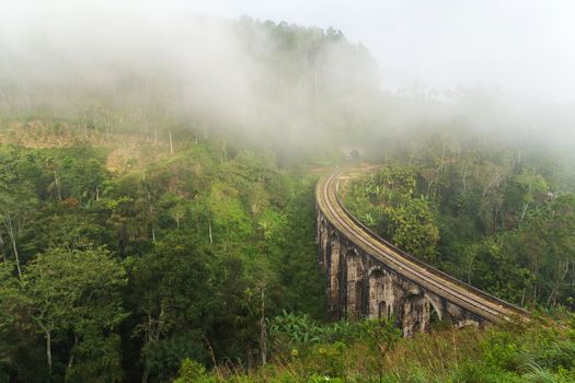 Nine Arch Bridge in Demodara fog and cloud mountain valley landscape.