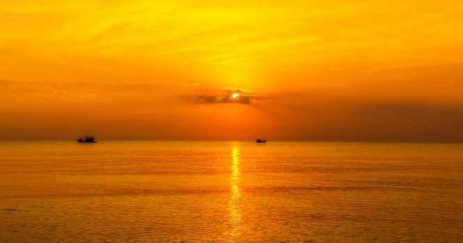 panoramic view of tropical surfers at sunset
